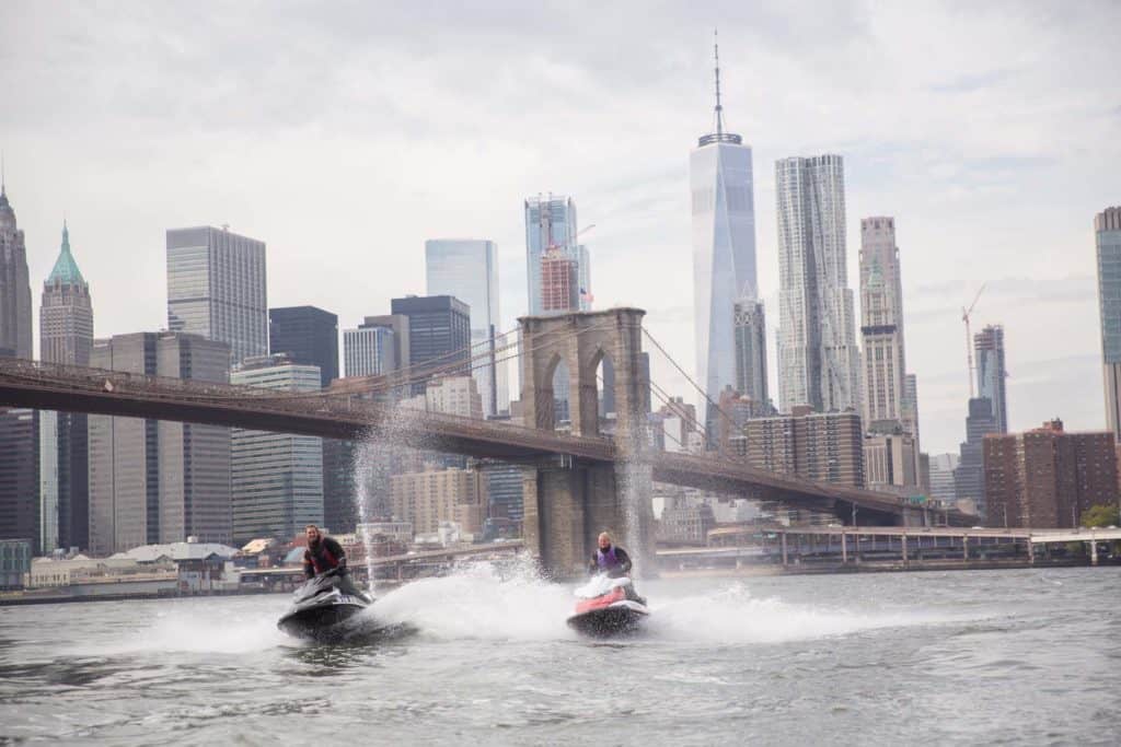 People on jet skis near the Brooklyn bridge
