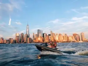 a large body of water with a city in the background