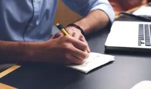 a man sitting at a table using a laptop