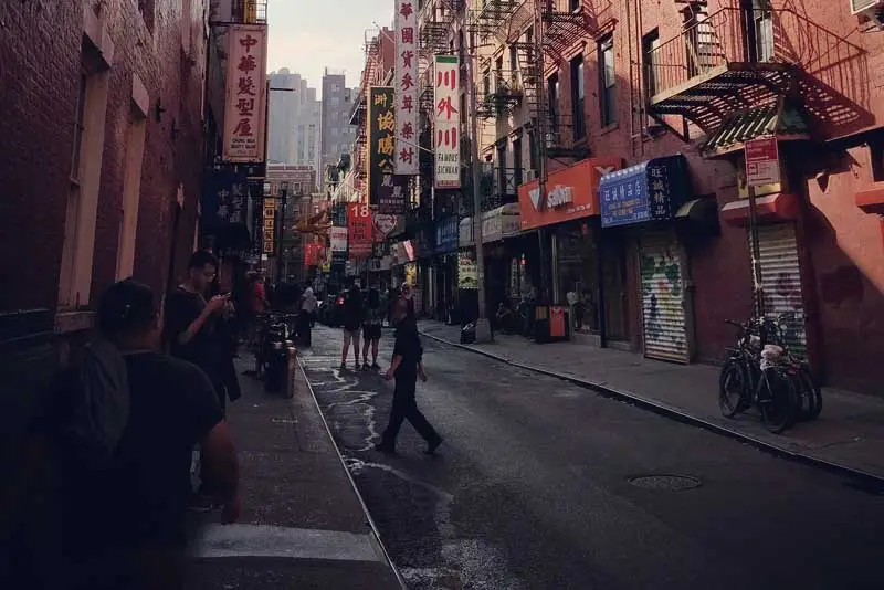 a group of people walking on a city street