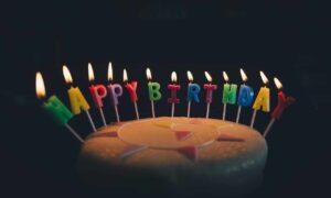 a birthday cake with lit candles