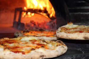 a pizza sitting on top of a pan on a stove top oven