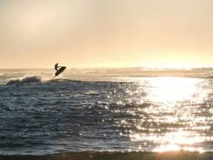 a man jet skiing in the sunset on the Hudson river