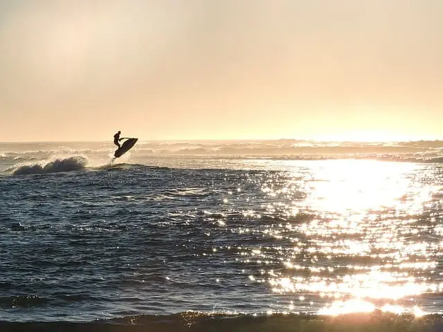 a man jet skiing in the sunset on the Hudson river