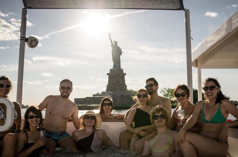 hot tub boat in front of statue of liberty