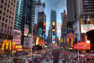 a close up of a busy city street with Times Square in the background