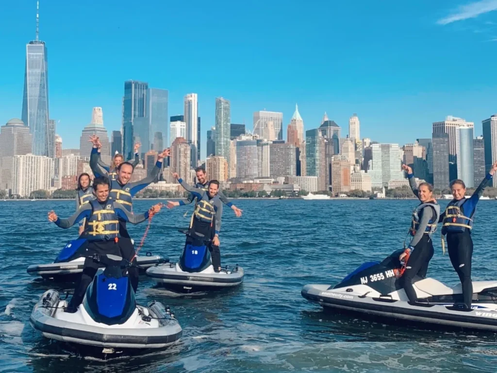 Guided jet ski tour passing the Statue of Liberty and Brooklyn Bridge in New York Harbor