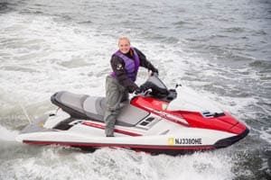 a person riding on the back of a boat in the water