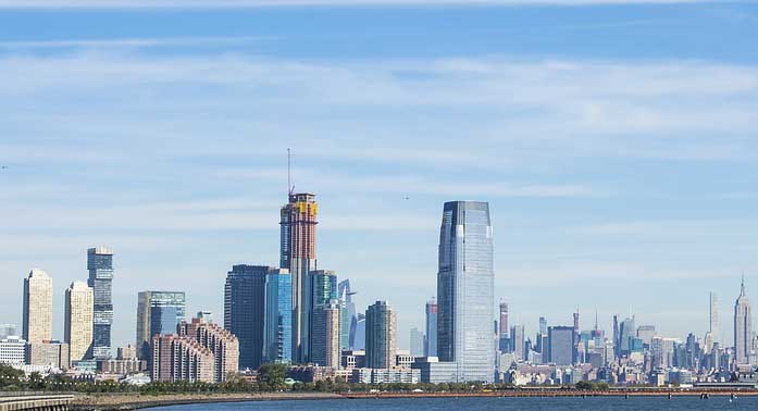 a large body of water with a city in the background