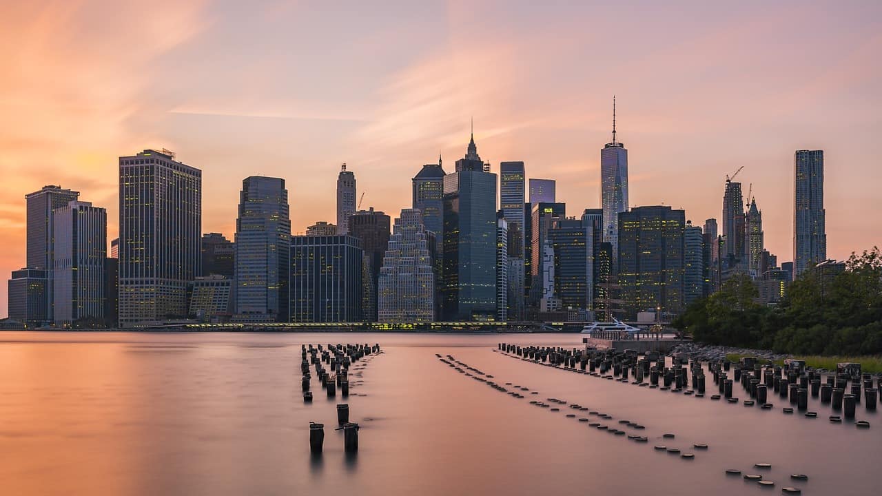 a large body of water with a city in the background