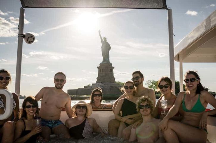 a group of people posing on the NYC Hot Tub Boat