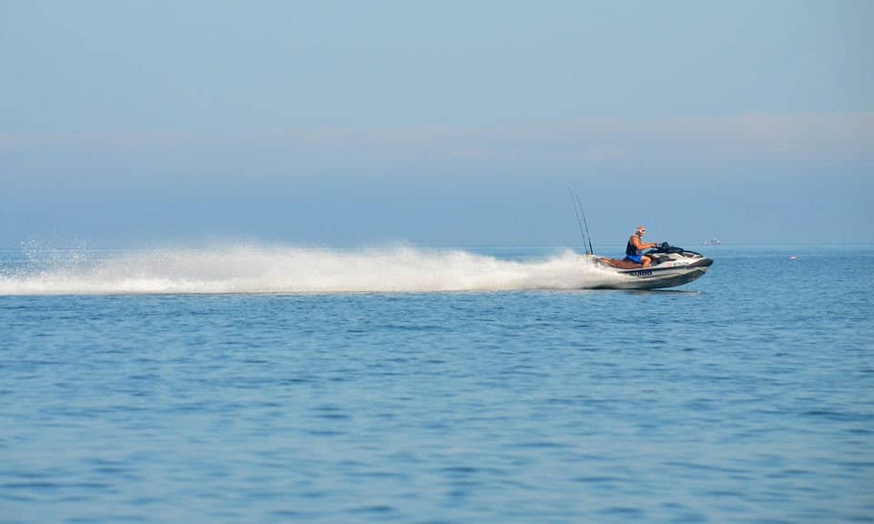 jetskiing in NY a small boat in a body of water