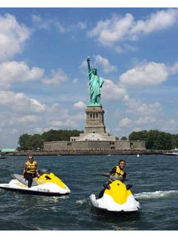 a group of people in a small boat in a body of water