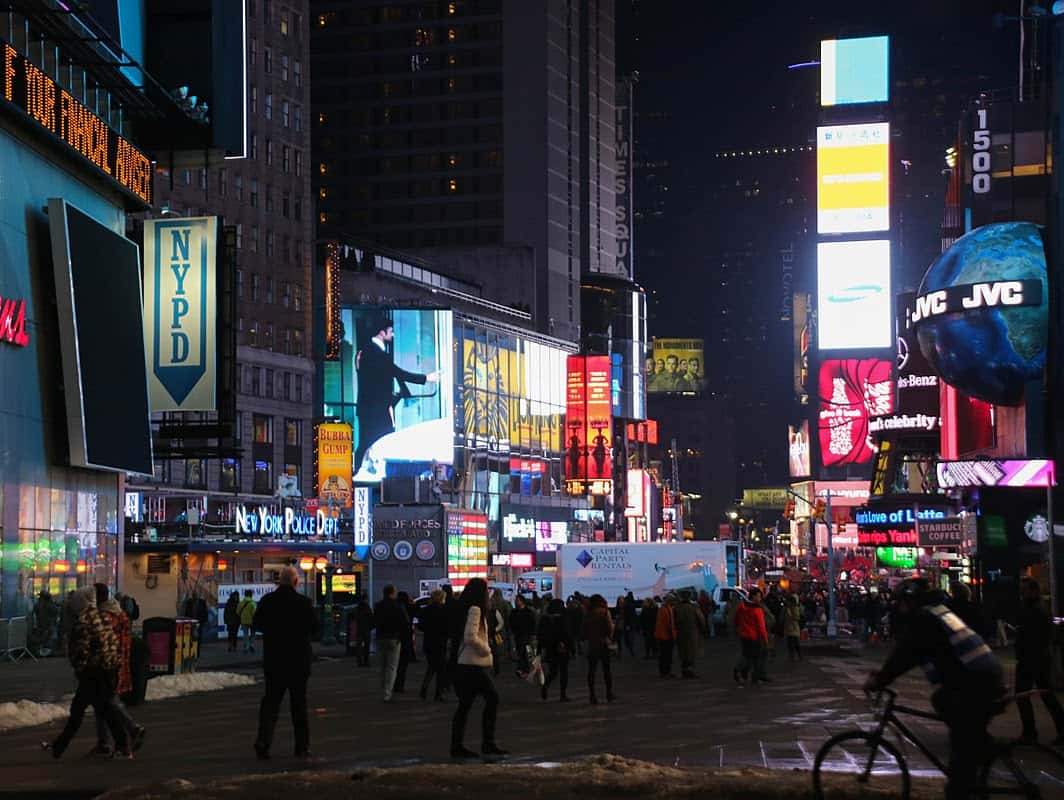 a group of people walking on a city street