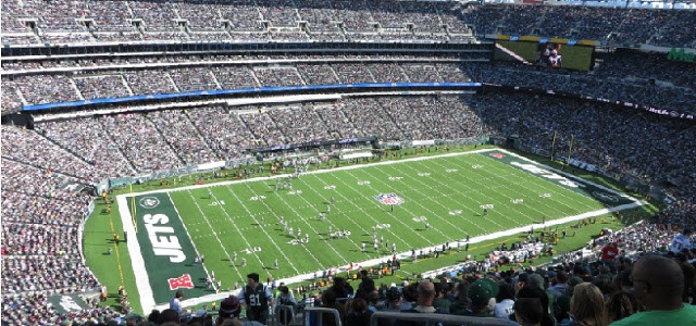 a stadium full of people with MetLife Stadium in the background