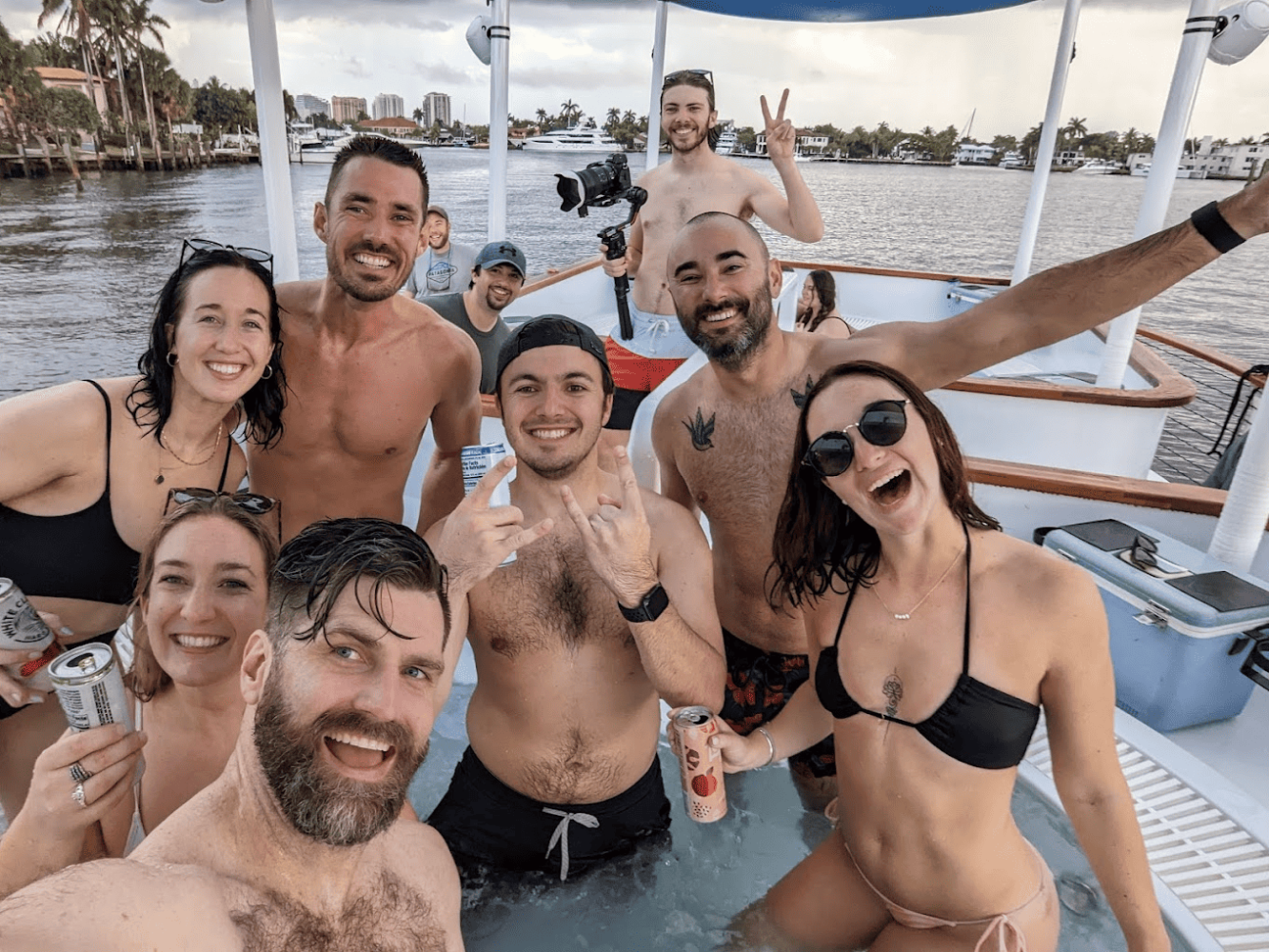 a group of people posing on hot tub boat in NYC