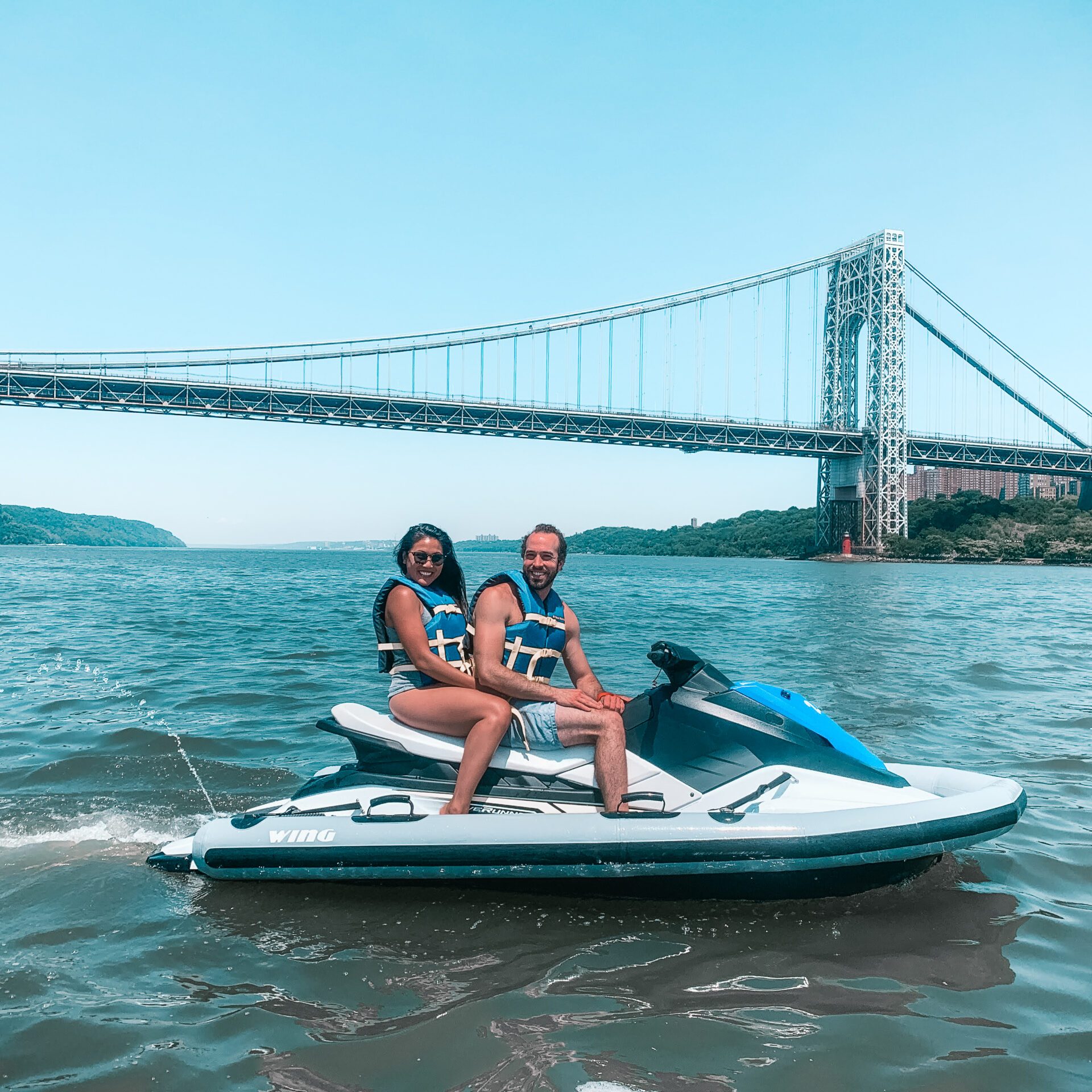 a person riding on the back of a boat in the water