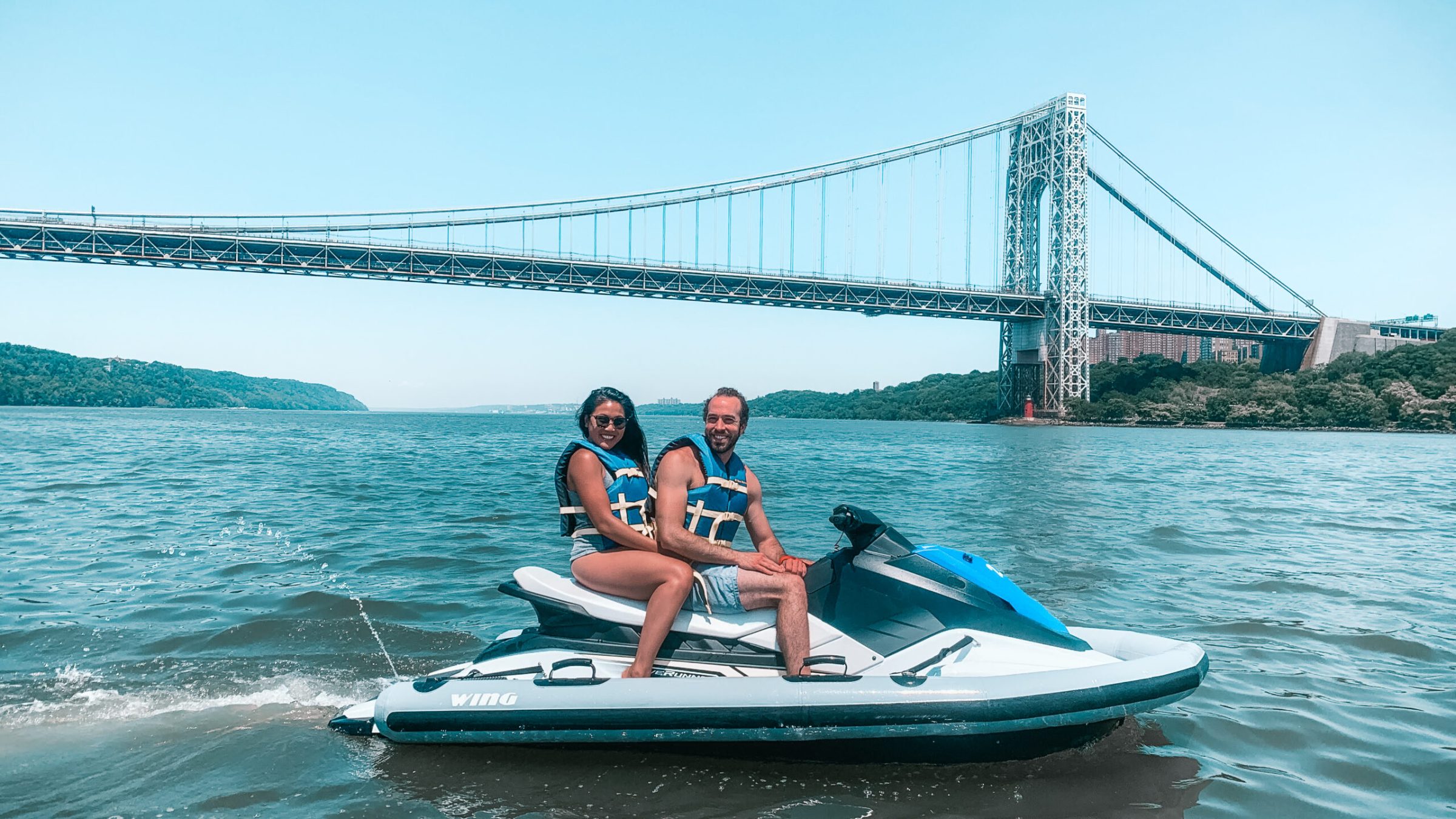 a person riding on the back of a boat in the water