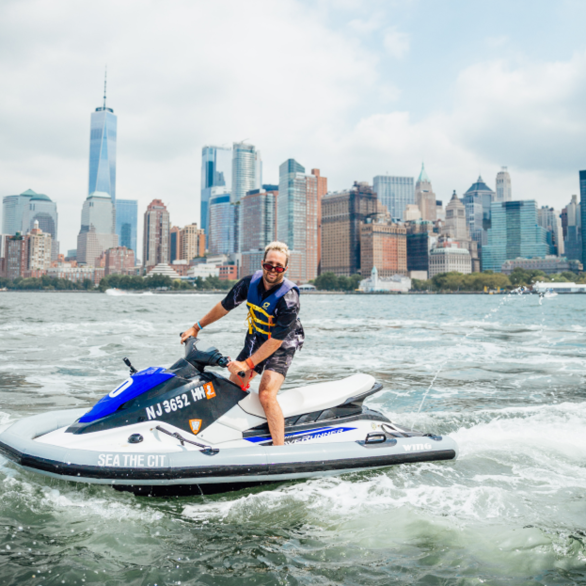 a man riding on the back of a boat in the water