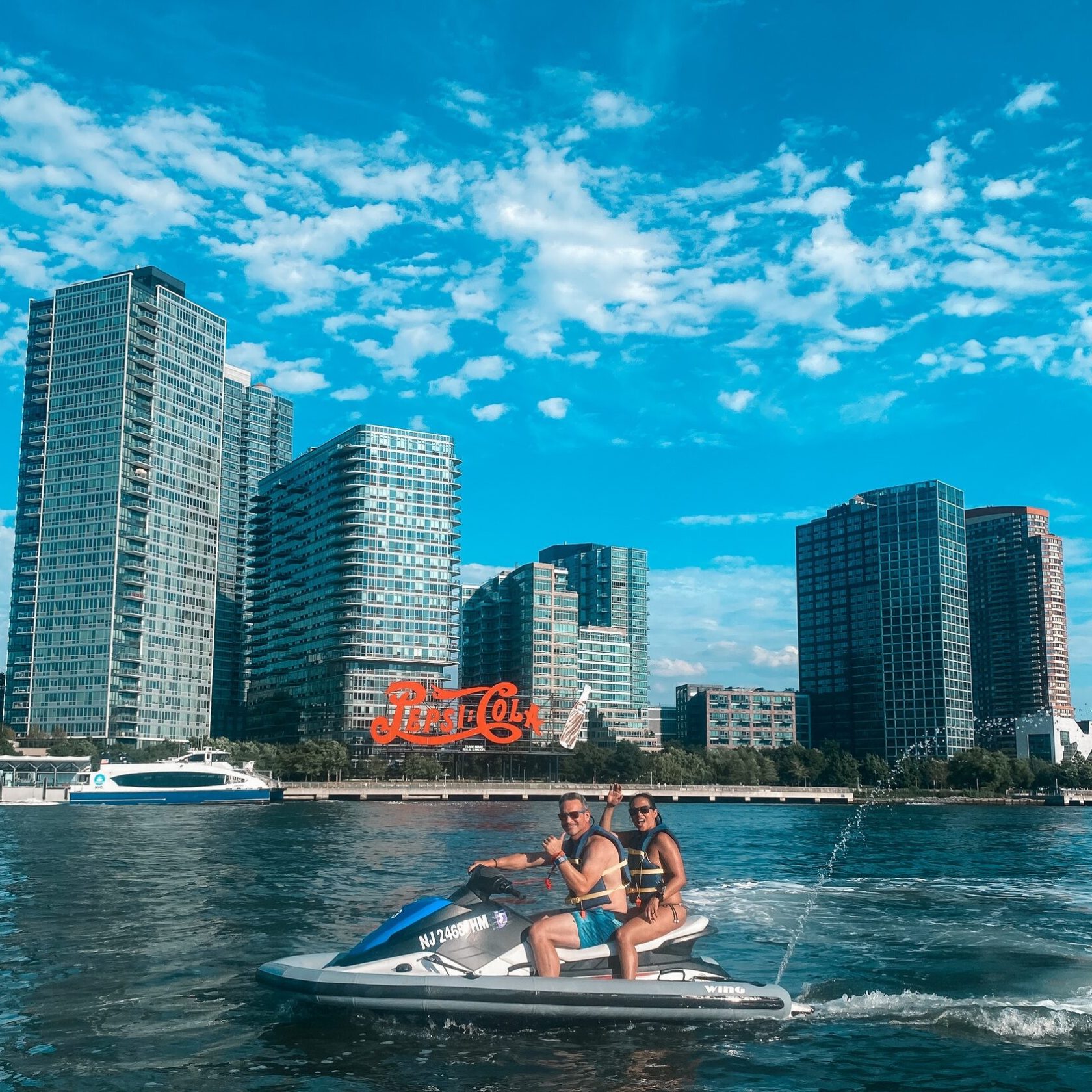 a large body of water with a city in the background