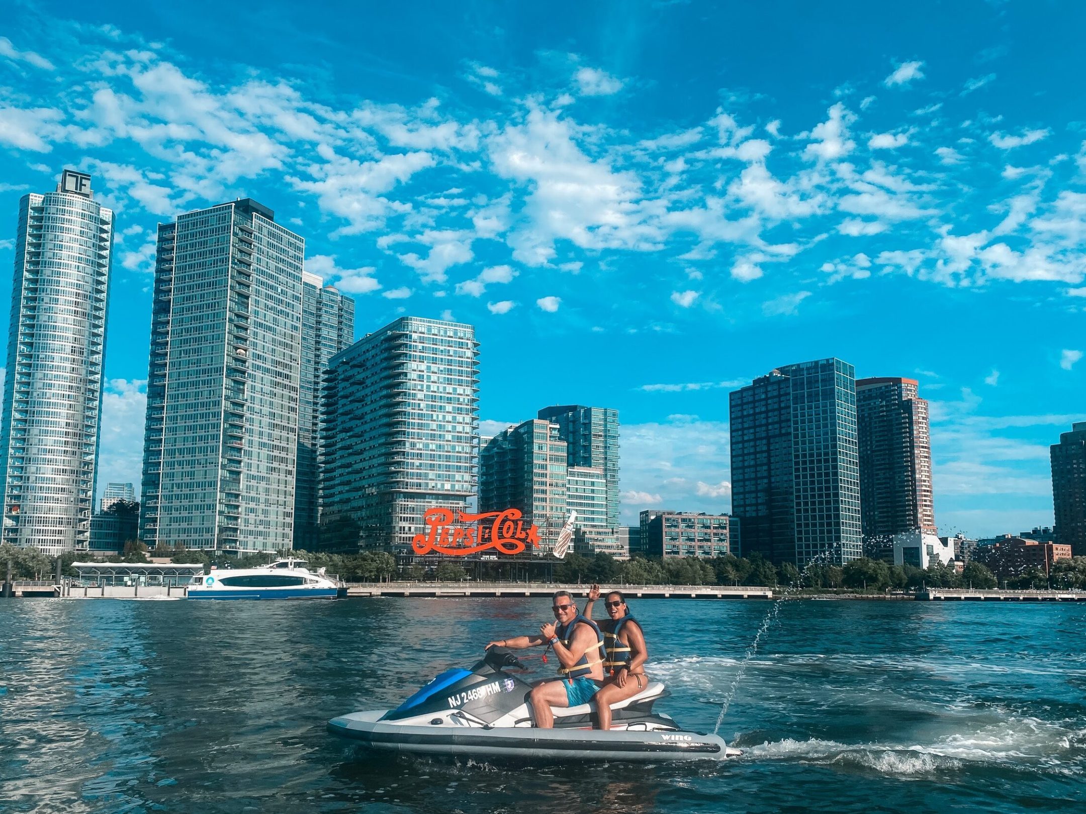 a large body of water with a city in the background