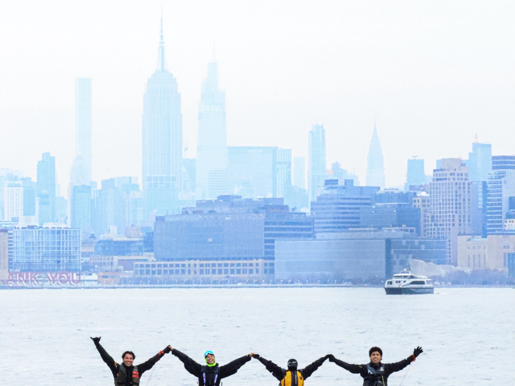 a group of people in a boat on a body of water