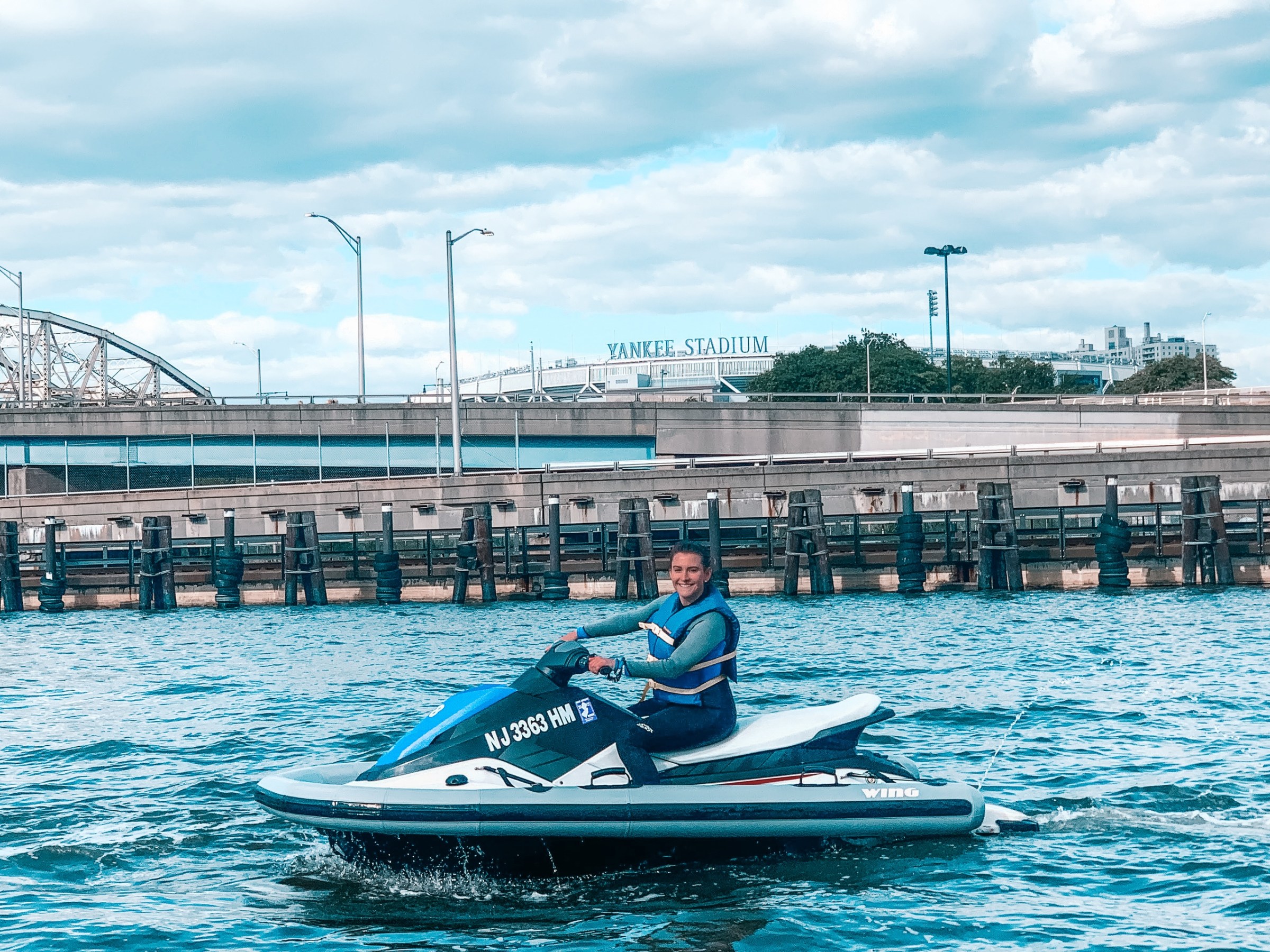 a man riding on the back of a boat in the water