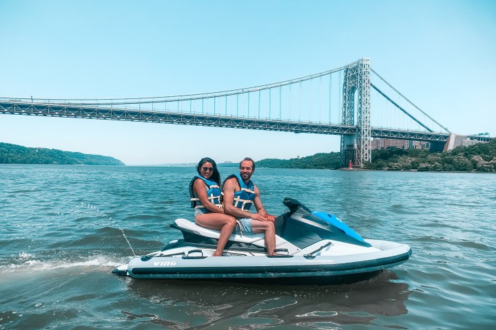 a person riding on the back of a boat in the water