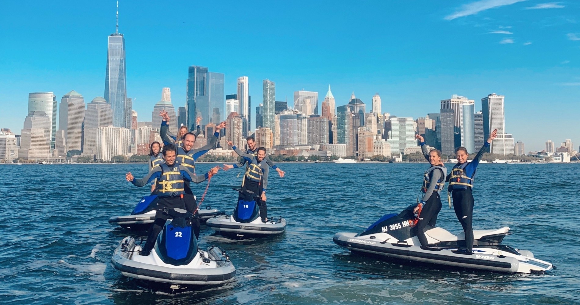 birthday party group of people riding on jet skis in the water