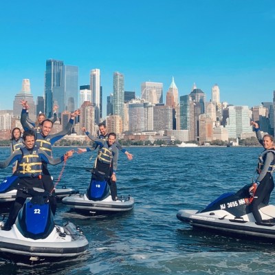 birthday party group of people riding on jet skis in the water