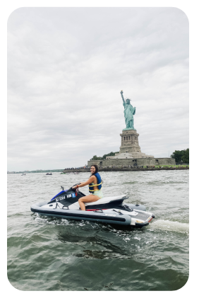 a man riding on the back of a boat in a body of water