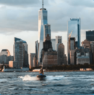 a body of water with a city in the background