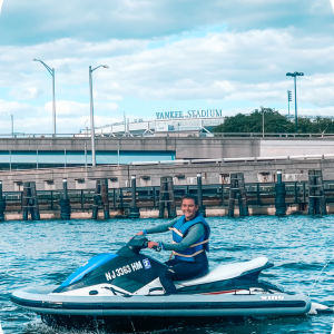 a blue and white boat sitting next to a body of water