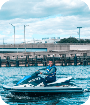 a blue and white boat sitting next to a body of water