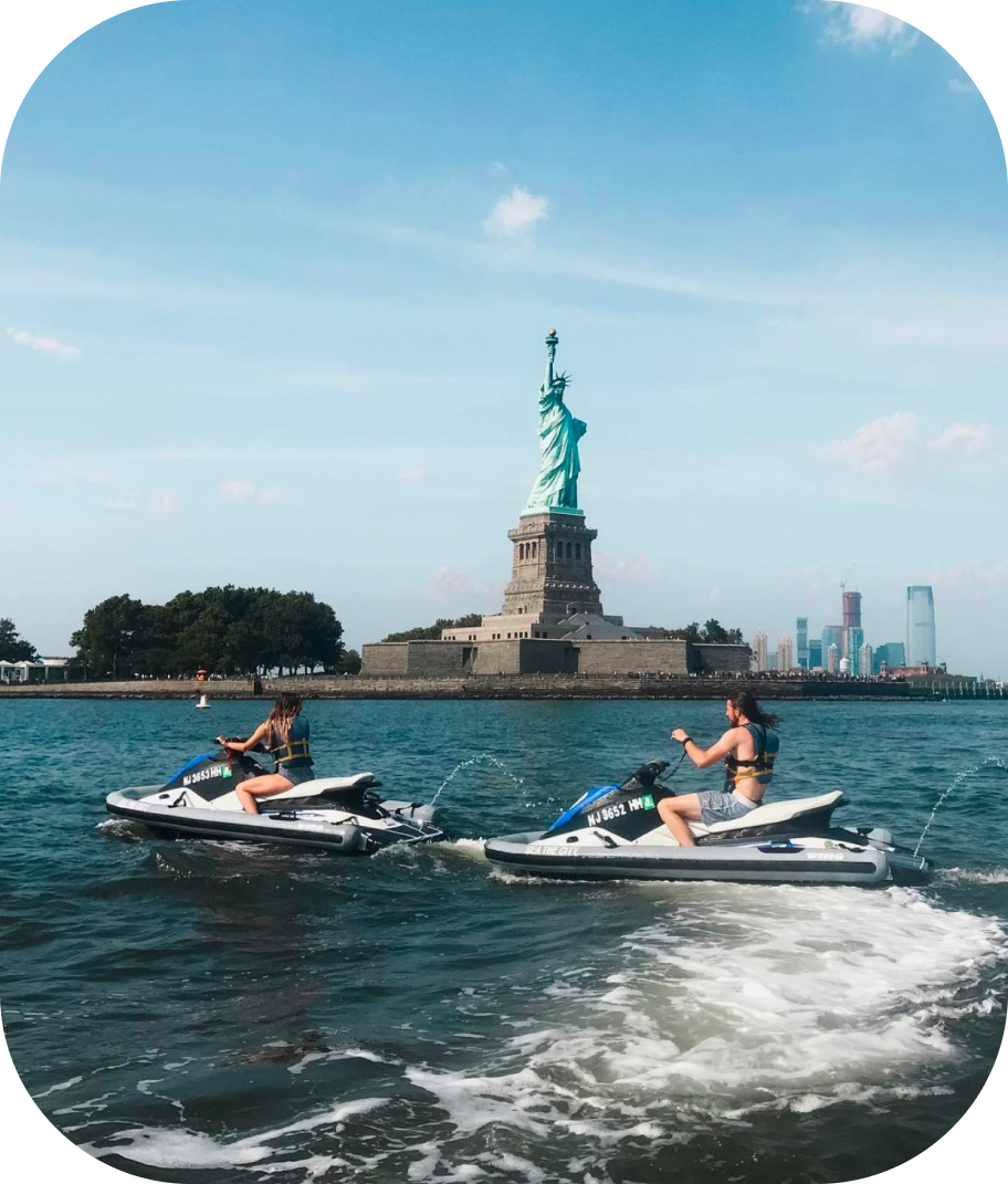 people on jet skis in front of the statue of liberty people on jet skis in front of the statue of liberty