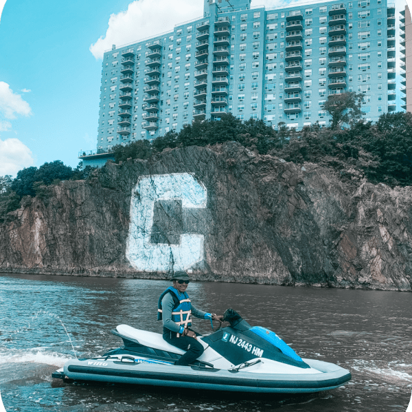 a group of people riding on the back of a boat in the water