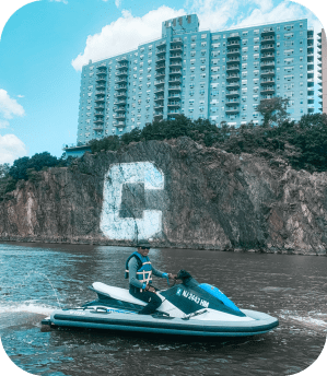 a group of people riding on the back of a boat in the water