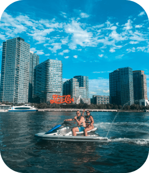 a man swimming in a body of water with a city in the background