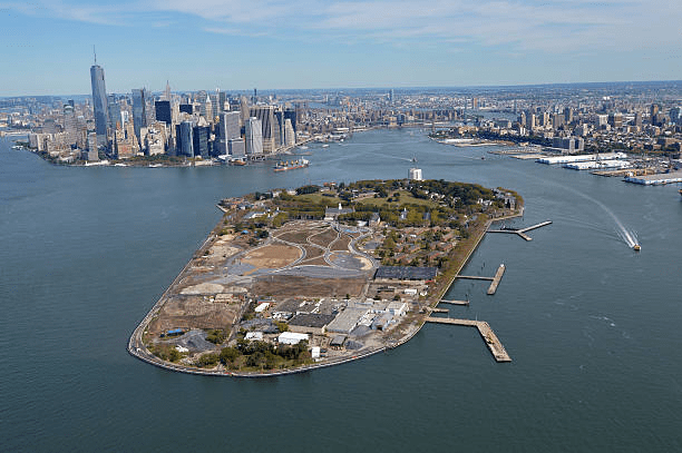 Aerial view of Governors Island with Manhattan skyline in the background.